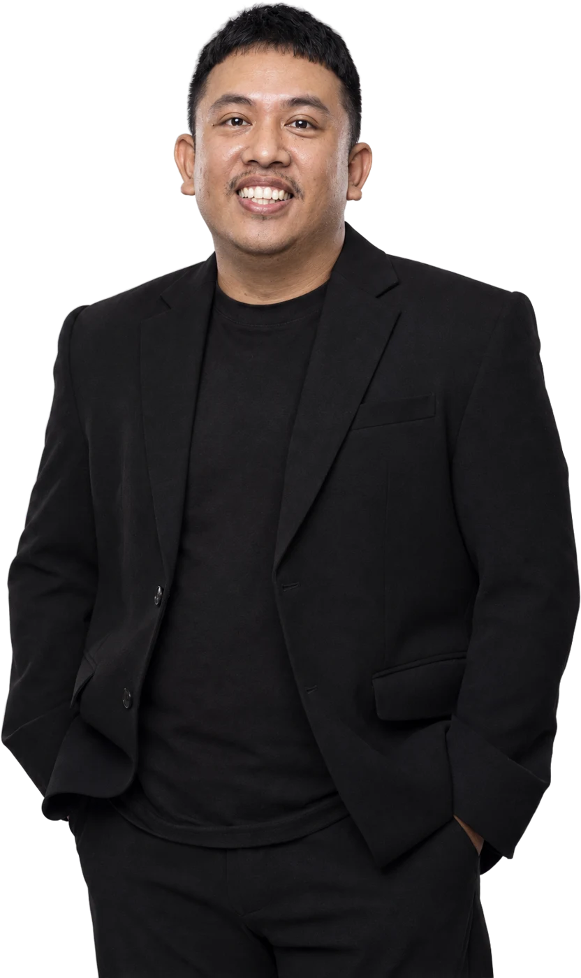 Jimmi Mohtar in a black blazer, smiling